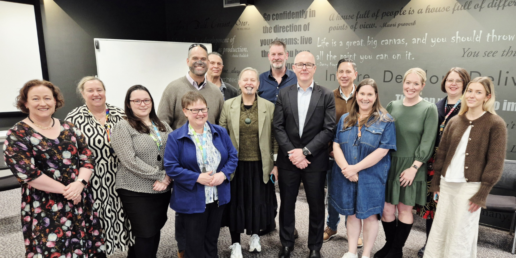 Mental Health First Aid (MHFA) International CEO Angus Clelland, centre, with some of the team from Te Pou and MHFA Aotearoa.